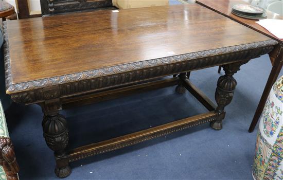 A 19th century Flemish carved oak centre table, on cup and cover legs, W.144cm